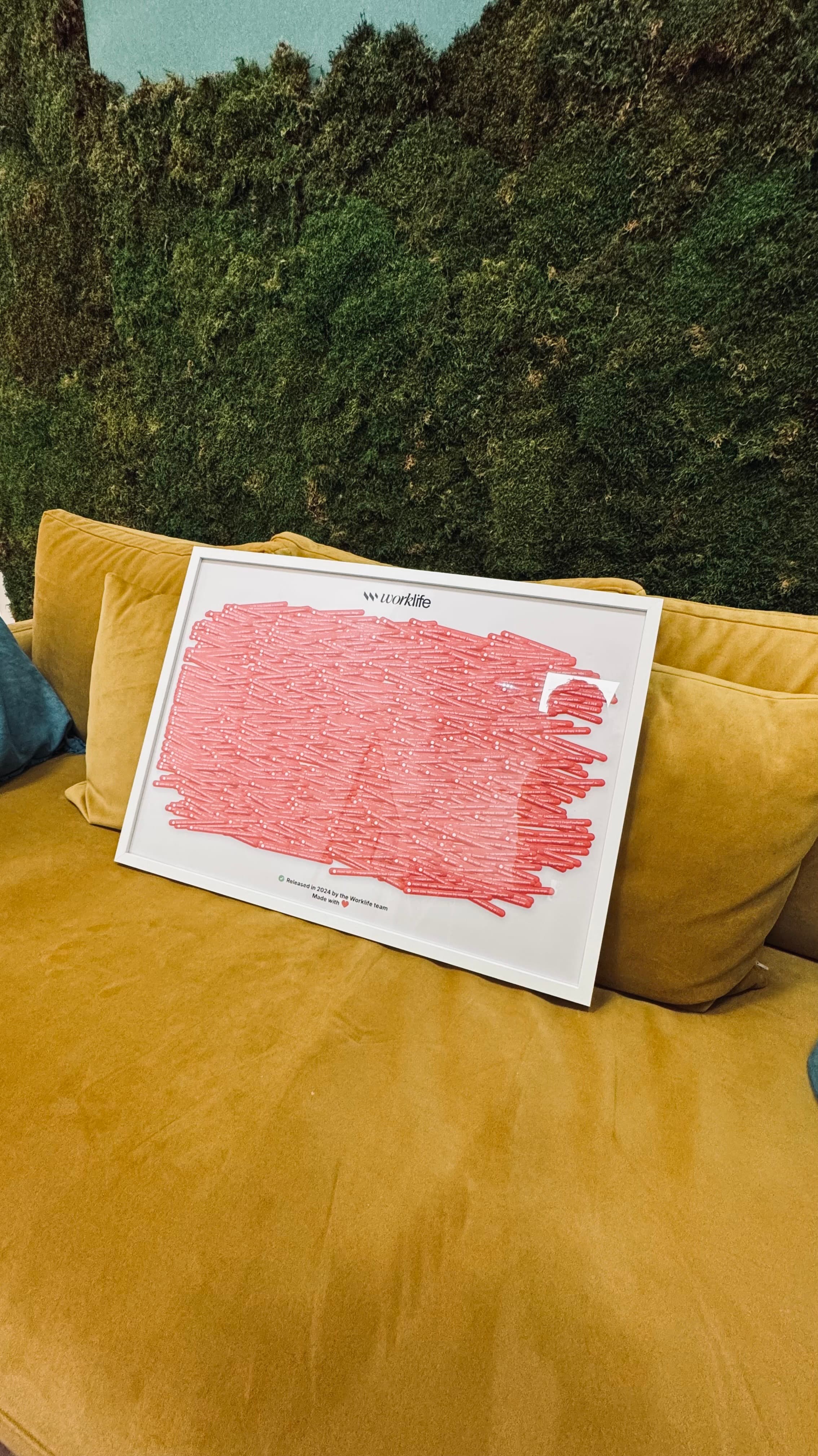 Pink Ticket Poster placed on a sofa in a lounge area